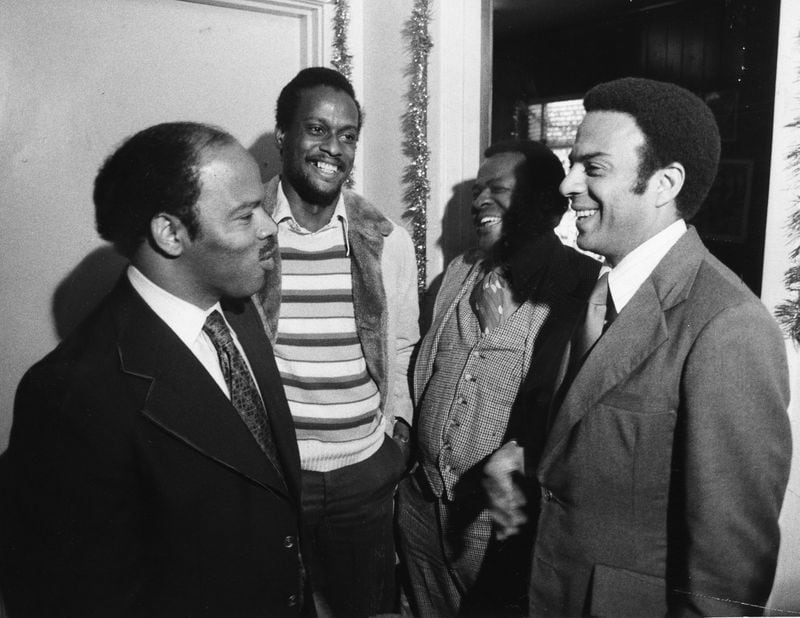 John Lewis laughs with Andrew Young and two others on Dec. 23, 1976. Lewis worked on Young's congressional campaigns in the 1970s before Young vacated the seat in 1977. In the 1980s, with Young as Atlanta mayor and Lewis on the City Council, the two saw their friendship tested on a number of issues. (Jerome McClendon / AJC Archive at GSU Library Jerome McClendon)