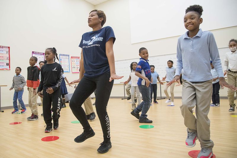 Harper-Archer Elementary School third graders mimic dance teacher Lisa Perrymond (center) as they learn more steps to an African themed dance they are learning during class inside the school's dance studio, Tuesday, January 28, 2020. (ALYSSA POINTER/ALYSSA.POINTER@AJC.COM)
