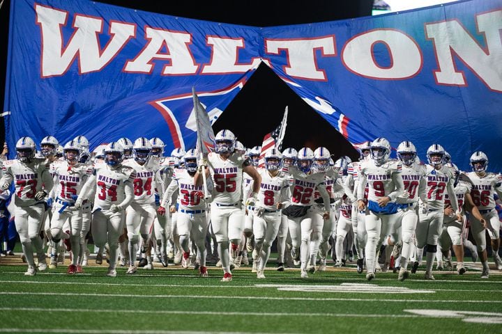 Walton High School takes the field for the game against Buford. (Jamie Spaar for the Atlanta Journal Constitution)