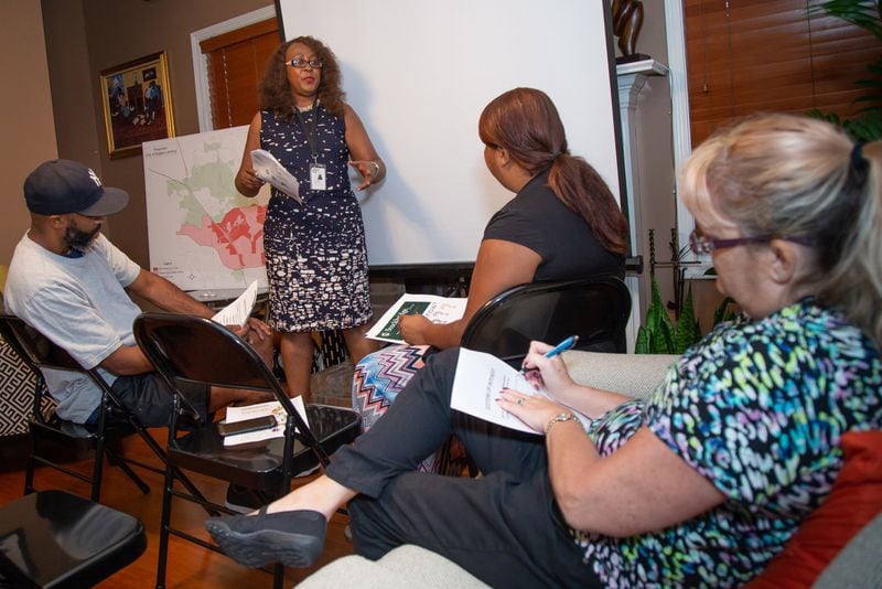 City of Stockbridge Assistant City Manager Camilla Moore talks to residents of Moss Pointe Subdivision during a gathering at Regina Lewis-Ward’s home about an upcoming ballot measure to make Eagle’s Landing a city. STEVE SCHAEFER / SPECIAL TO THE AJC