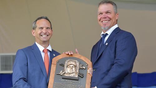 Chipper Jones shows off some new hardware to go on the wall at the Baseball Hall of Fame. He's joined by Jeff Idelson, the Hall's president. (HYOSUB SHIN / HSHIN@AJC.COM)