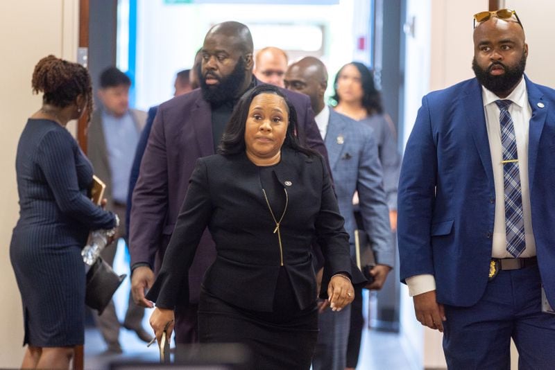 Fulton County District Attorney Fani Willis (center) expects to announce charging decisions soon in her investigation into efforts by Donald Trump and his allies to overturn Georgia's 2020 presidential election result. (Arvin Temkar / arvin.temkar@ajc.com)