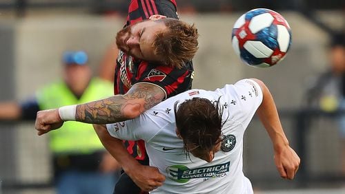 July 10, 2019 Kennesaw: Atlanta United defender Leandro Gonzalez Pirez collides with St. Louis forward Russell Cicerone as they battle for the ball in a U.S. Open Cup quarterfinals soccer match on Wednesday, July 10, 2019, in Kennesaw.  Curtis Compton/ccompton@ajc.com