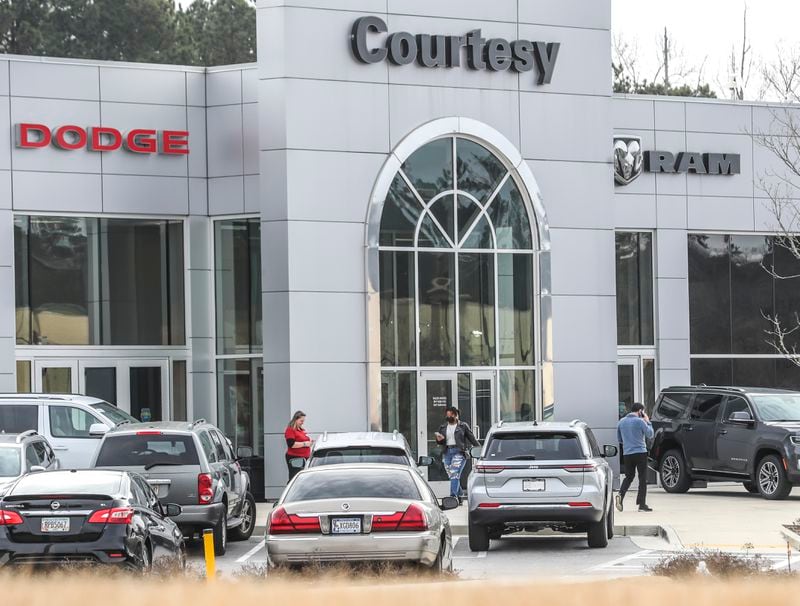 February 21, 2022 Stonecrest: Courtesy Chrysler Dodge dealership near the Stonecrest mall was back open on Monday, Feb. 21, 2022 as DeKalb County police are investigating after a security guard was shot and killed at the car dealership near the Mall at Stonecrest on Saturday night, officials said. Officers were called around 11 p.m. to the area of 8455 Mall Parkway, DeKalb police spokesperson Michaela Vincent said. They found Henry Ashley, who worked as a security guard at the Courtesy Chrysler Dodge dealership near the mall, with a gunshot wound. He was taken to a hospital, where he died. Investigators determined Ashley, 24, was investigating a suspicious person alert on the property when he encountered a group of suspects, according to a news release. Moments later, he was shot while in his marked work vehicle. In a still of security camera footage released by police, at least five suspects can be seen walking through the dealershipÕs parking lot. No suspects have been arrested, the news release states. Police are asking the public for help in identifying the five suspects. In an interview with Channel 2 Action News, the victimÕs wife said she had been on the phone with him just minutes before the shooting. ÒI have to stay strong for my son,Ó Kyla Rushton said. ÒHe lost his daddy. I hope whatever they wanted here was more important than his life.Ó Police searching for 5 suspects after 24-year-old security guard shot, killed at car dealership Police ask anyone with information about the incident to call detectives at 770-724-7850 or to contact Crime Stoppers Atlanta by calling 404-577-8477, texting information to 274637 or visiting the Crime Stoppers website. Tipsters may be eligible to receive up to a $2,000 reward. (John Spink / John.Spink@ajc.com)

