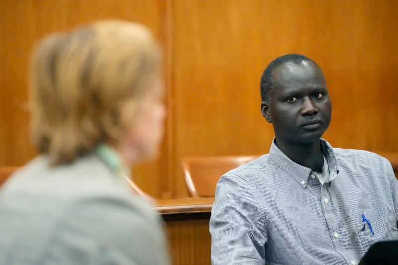Bul Mabil, brother of Dau Mabil, a 33-year-old Jackson, Miss., resident who went missing on March 25 and whose body was found in April floating in the Pearl River in Lawrence County, stares at his brother's widow, Karissa Bowley, during a recess at a hearing, on whether a judge should dissolve or modify his injunction preventing the release of Mabil's remains until an independent autopsy could be conducted, Tuesday, April 30, 2024, in Jackson, Miss. (AP Photo/Rogelio V. Solis)