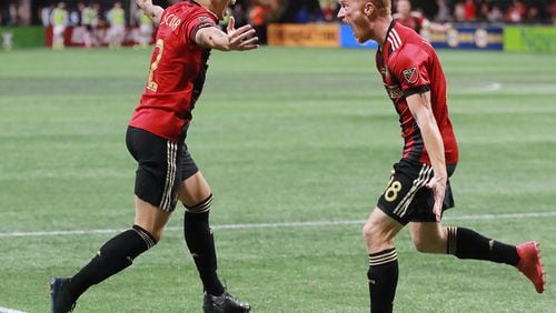 12/8/18 - Atlanta - Atlanta United player Franco Escobar (left) reacts to scoring his goal with teammate jeff Larentowicz against the Portland Timbers for a 2-0 lead in the MLS Cup, the championship game of the Major League Soccer League at Mercedes-Benz Stadium in Atlanta.   CURTIS COMPTON / CCOMPTON@AJC.COM