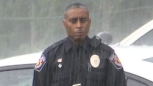 Standing in the pouring rain, Officer Newman Brazier of the Mount Vernon Police Department honored his fellow veteran, Private First Class Robert Lee Serling.