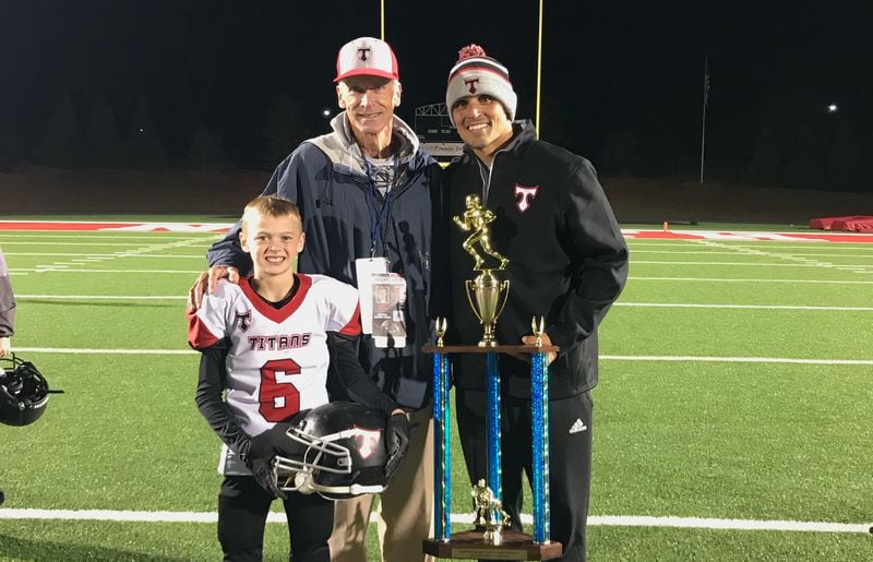 Jon Fabris (L) coached David Pollack (R) in college. Now Pollack is coaching Fabris' son Michael in youth league football, and Fabtis is one of his assistants. (Family photo)