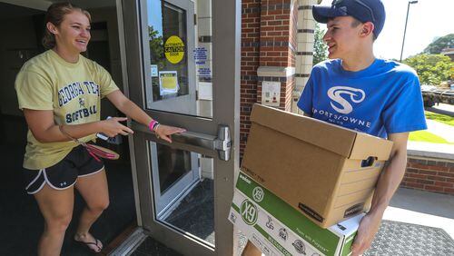 LEDE PHOTO - August 15, 2016 Atlanta: Georgia Tech freshman, Isabella Many-18 from New Jersey (left) opens the door for 2nd year student, Carter Floyd-19 (right) who came early to move in at the Eighth Street Apartments on campus on Monday, Aug. 15, 2016.