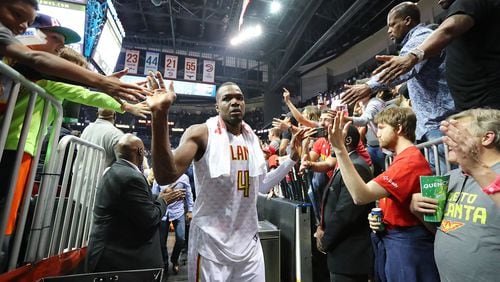 Atlanta Hawks forward Paul Millsap gets high-fives from fans after his team beat the Washington Wizards 111-101 in Game 4 of a first-round playoff series on Monday, April 24, 2017, in Atlanta. (Curtis Compton/ccompton@ajc.com)