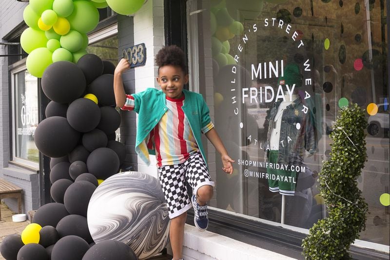Erin dances outside of Mini Friday, a children’s street wear clothing store inspired by her fashion, during the store’s grand opening celebration. Her mother, Allie Friday, found it hard to shop for her daughter’s unique style and decided to open a retail store in order to offer her daughter, and other kids, an alternative option for clothing. (ALYSSA POINTER/ALYSSA.POINTER@AJC.COM)