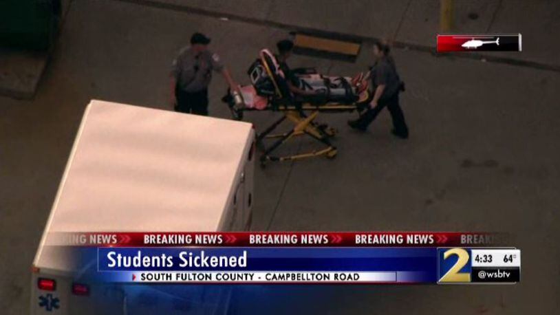 Authorities take a student out of the school on a stretcher and place him in an ambulance Thursday.