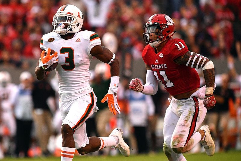 RALEIGH, NC - NOVEMBER 19: Stacy Coley #3 of the Miami Hurricanes runs during his 51-yard pass catch against Josh Jones #11 of the North Carolina State Wolfpack at Carter-Finley Stadium on November 19, 2016 in Raleigh, North Carolina. Miami won 27-13. (Photo by Lance King/Getty Images)