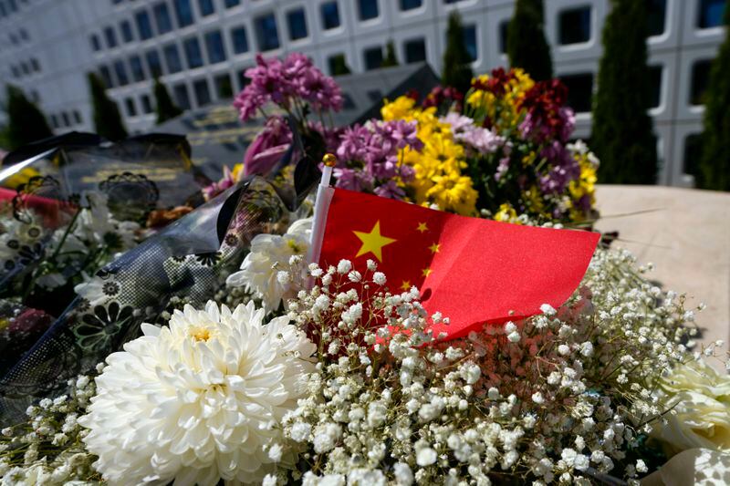 A Chinese flag is placed near flowers on a monument at the site of a former Chinese Embassy in Belgrade, Serbia, Monday, April 29, 2024. During NATO bombing campaign, in 1999, jets bombed the Chinese Embassy in Belgrade, killing three people and at least 20 were injured. Chinese leader Xi Jinping will spend the bulk of his five-day tour in Europe this week in two small countries at the continent’s eastern half, Hungary and Serbia. (AP Photo/Darko Vojinovic)