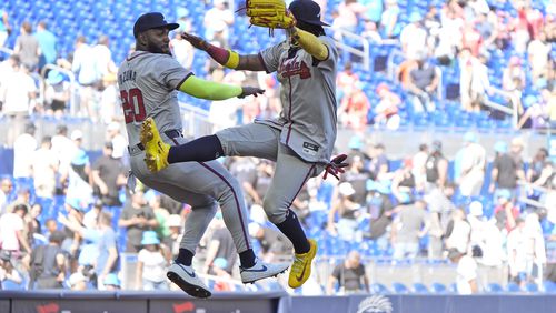 Atlanta Braves designated hitter Marcell Ozuna (20) and right fielder Ronald Acuna Jr. celebrate after the Braves beat the Miami Marlins, 9-7, in a baseball game, Sunday, April 14, 2024, in Miami. (AP Photo/Wilfredo Lee)