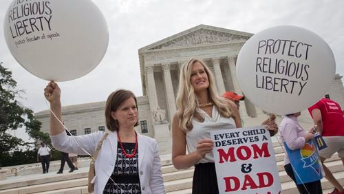 Jennifer Marshall and Summer Ingram, with the Congressional Prayer Caucus Foundation, who said they support "traditional marriage" outside of the Supreme Court Friday June 26, 2015, in Washington, before the court declared that same-sex couples have a right to marry anywhere in the US. (AP Photo/Jacquelyn Martin)