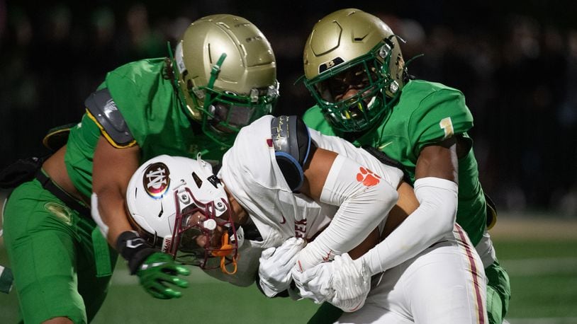 Jamal Anderson gets taken down at the Buford/Mill Creek football game (Photo Jamie Spaar for The Atlanta Journal-Constitution)