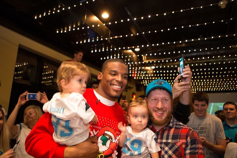 Cam Newton, shown here spreading holiday cheer earlier this month, announced happy news Wednesday night: he's a dad! Photo: Cam Newton Foundation/Andreas Seibold.