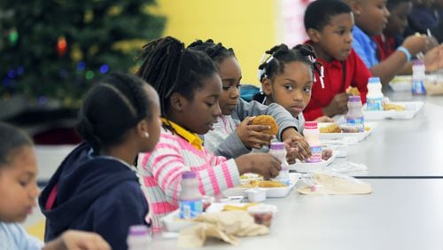 Students eat lunch at Stewart County Elementary School. All of the county’s 515 students receive free breakfasts and lunches. And if the county wins a federal grant, its students will start receiving free dinners. BOB ANDRES /BANDRES@AJC.COM