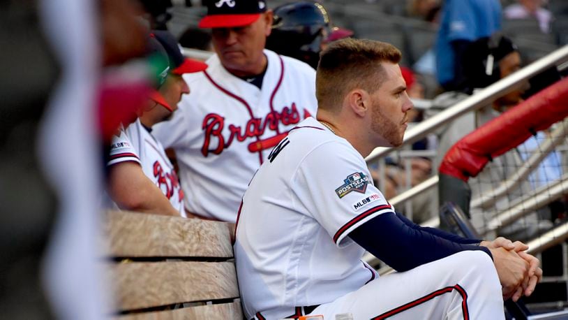 Atlanta Braves' Freddie Freeman sits in the dugout during the second inning of Game 5 of their National League Division Series loss to the St. Louis Cardinals, Wednesday, Oct. 9, 2019, in Atlanta.