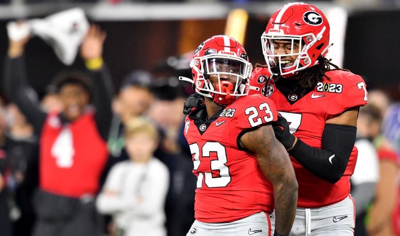Georgia Bulldogs defensive back Tykee Smith (23) and Georgia Bulldogs linebacker Marvin Jones Jr. (7) react after stopping the TCU Horned Frogs as captain and defensive end Nolan Smith signals from the sideline during the second half of the College Football Playoff National Championship at SoFi Stadium in Los Angeles on Monday, January 9, 2023. Georgia won 65-7 and secured a back-to-back championship. (Hyosub Shin / Hyosub.Shin@ajc.com)
