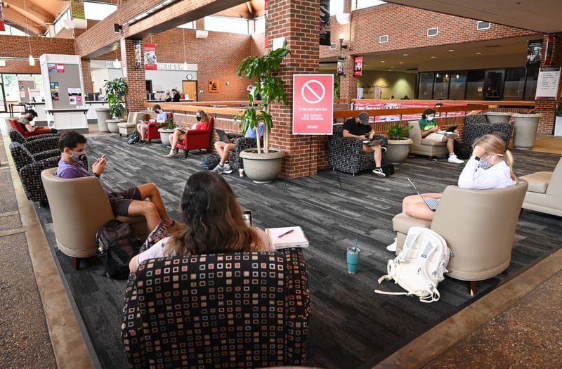 In this file photo, students sit inside Tate Student Center while socially distanced and wearing masks as the University of Georgia. (Hyosub Shin / Hyosub.Shin@ajc.com)