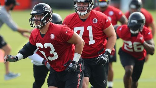 July 27, 2017 Flowery Branch: Falcons offensive guards Ben Garland (from left) and Wes Schweitzer look to block for running back Tevin Coleman on the first day of team practice at training camp on Thursday, July 27, 2017, in Flowery Branch. Curtis Compton/ccompton@ajc.com