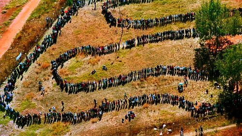 FILE - People queue to cast their votes In Soweto, South Africa April 27, 1994, in the country's first all-race elections. In 1994 people braved long queues to cast a vote after years of white minority rule which denied Black South Africans the vote. (AP Photo/Denis Farrell. File)