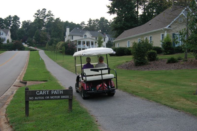 A golf cart serves as transportation of choice for local trips around Peachtree City.  Photo taken in Planterra Ridge neighborhood. (JANNELLE MIMMS/ Special)
