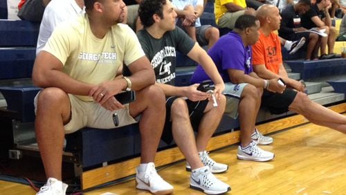 Georgia Tech coach Josh Pastner (second from left) and assistant coach Tavaras Hardy watch an AAU game at Spring Valley High in Las Vegas Thursday. (AJC photo by Ken Sugiura)