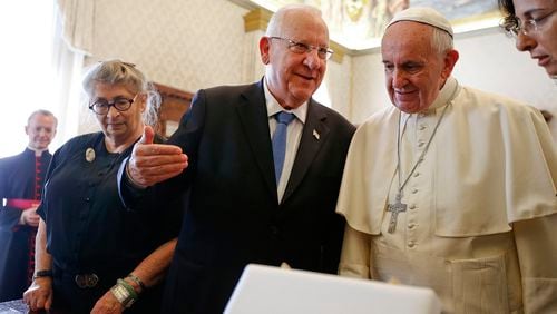 Pope Francis and Israel's President Reuven Rivlin exchange gifts during a private audience in the Pontiff's private library at the Vatican Thursday. The pontiff is preparing to address the U.S. Congress on Sept. 24.