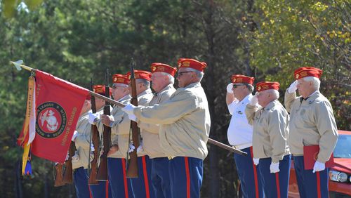 John Newport, second from right, salutes with other members of the Marine Corps League Woodstock detachment’s Ceremonial Rifle Team at Georgia National Cemetery in Canton on Friday, November 1, 2019. (Hyosub Shin / Hyosub.Shin@ajc.com)