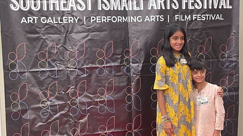 Sufi Momin, 12, poses with her brother Rumi at a Southeast Ismaili Arts Festival event. Sufi created a short documentary about biodiversity and climate change that will be screened Sept. 16 at the festival held at the Rialto Center for Performing Arts at Georgia State University. (Courtesy of Behnoosh Momin)