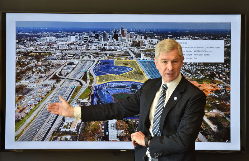 Georgia State President Mark Becker shows off new renderings showing the design concepts of what GSU hopes to build on the 68-acre site. HYOSUB SHIN / HSHIN@AJC.COM
