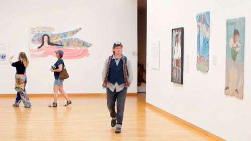 Matt Arnett strolls through the Folk and Self Taught Art exhibit at the High Museum of Art.