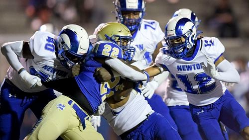McEachern running back Makari Bodiford (22) is stopped by Newton’s defense in the first half of Friday's game at McEachern.