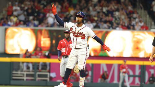 Braves second baseman Ozzie Albies reacts after connecting a two-run double in the second inning at Truist Park on Tuesday, April 12, 2022. Miguel Martinez/miguel.martinezjimenez@ajc.com