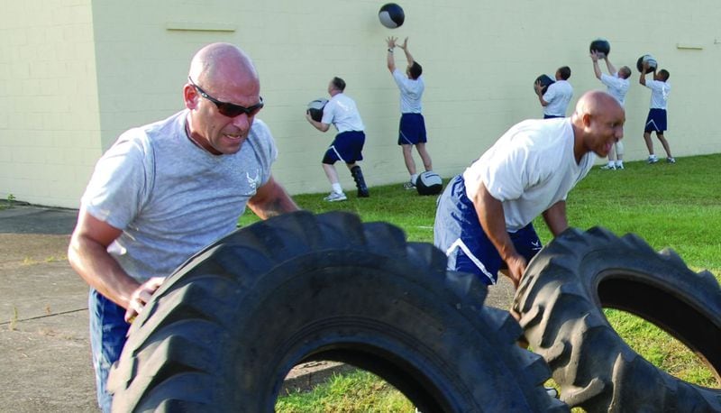 Senior Master Sgt. Robert "Bob" Orsi, left, is pictured in 2009 during fitness activities at Maxwell Air Force Base in Montgomery, Alabama. Orsi, who subsequently retired from the U.S. Air Force, is accused of shooting his wife and triplet 12-year-old daughters Saturday, July 7, 2018, at the family's home near Wetumpka before setting the house on fire and turning his gun on himself. Two of the girls survived, but one triplet, Cadence Orsi, died, as did Orsi's wife, Charlene "Charley" Orsi, 44. A 13-year-old daughter escaped the shooting unharmed.