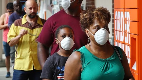 March 29, 2020 Atlanta: Customers wait in line to enter the Home Depot store at Midtown Place while the store limits the number of occupants to maintain six feet of space between shoppers and help prevent the spread of coronavirus on Sunday, March 29, 2020, in Atlanta.   Curtis Compton ccompton@ajc.com