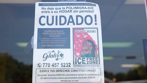 A sign is posted on the front door of La Major de Michoacan, located at 403 Atlanta Highway, in Gainesville, September 10, 2019. The sign lets guests of the ice cream shop know that Immigration and Customs Enforcement officers are not permitted inside their homes unless they have a signed warrant. (Alyssa Pointer/alyssa.pointer@ajc.com)