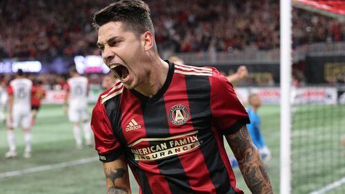 Atlanta United player Franco Escobar reacts as teammate Hector Villalba scores a goal against D.C. United for a 3-0 lead in the home opener during the second half in a MLS soccer match on Sunday, March 11, 2018, in Atlanta. Atlanta United won the game 3-1.    Curtis Compton/ccompton@ajc.com
