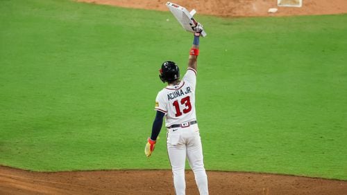 Atlanta Braves’ Ronald Acuna Jr. (13) holds up second base after he stole his 70th base of the season during the 10th inning against the Chicago Cubs at Truist Park, Wednesday, Sept. 27, 2023, in Atlanta. (Jason Getz / Jason.Getz@ajc.com)