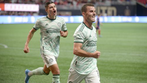 Atlanta United forward Ronaldo Cisneros (29) celebrates with defender Brooks Lennon (11) after Lennon scores the fourth and final goal against Chicago Fire FC Saturday, May 7, 2022 at the Mercedez-Benz Stadium. (Daniel Varnado/For the Atlanta Journal-Constitution)