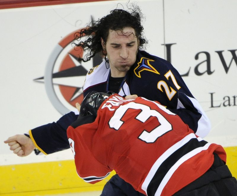 Atlanta Thrashers' Chris Thorburn (27) fights with New Jersey Devils' Mark Fayne during the second period of an NHL hockey game Friday, Dec. 31, 2010, in Newark, N.J.