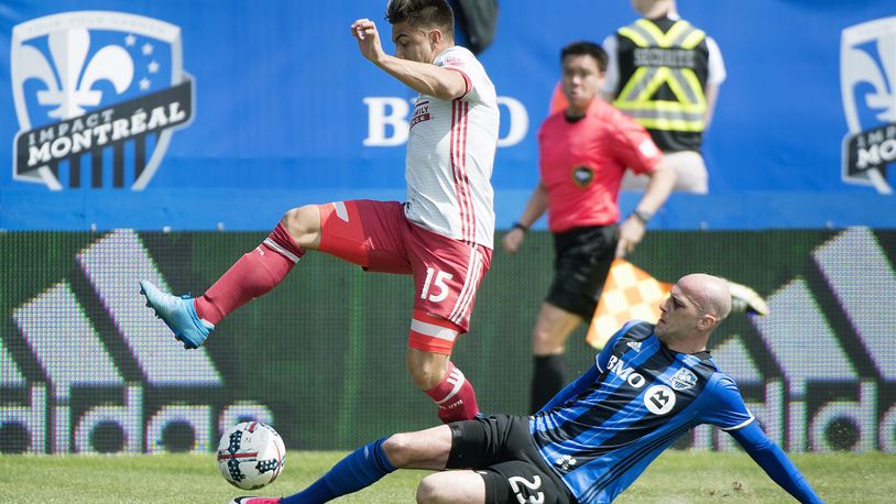 Montreal Impact’s Laurent Ciman, right, challenges Atlanta United’s Hector Villalba during first half of an MLS soccer game in Montreal, Saturday, April 15, 2017. (Graham Hughes/The Canadian Press via AP)