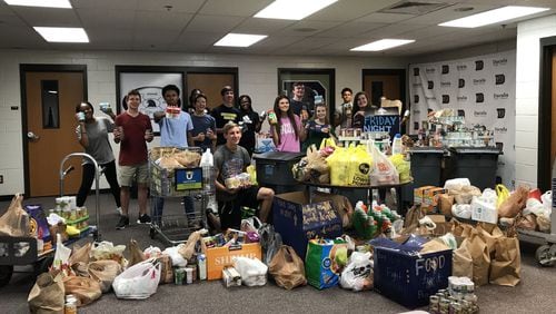Dacula High School Student Council members take a break from weighing donations during the 2018 Food Fight. COURTESY OF SYDNEY BENSON/DACULA HIGH SCHOOL