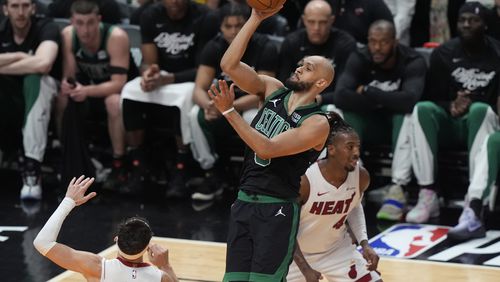 Boston Celtics guard Derrick White (9) scores over Miami Heat guard Tyler Herro (14) during the first half of Game 4 of an NBA basketball first-round game, Monday, April 29, 2024, in Miami. (AP Photo/Marta Lavandier)