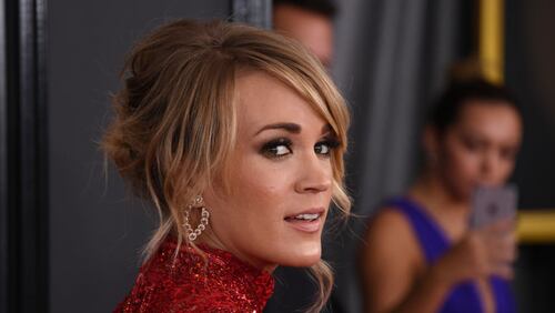 Carrie Underwood is pictured here arriving at the the 59th annual Grammy Awards in February in Los Angeles, California. She made a surprise appearance at the Nashville Pedators game against the Chicago Blackhawks in the first round of the Stanley Cup  playoffs to sing the national anthem.