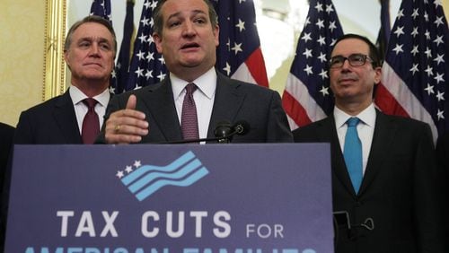 WASHINGTON: U.S. Sen. Ted Cruz, R-Texas, speaks as U.S. Sen. David Perdue, R-Georgia, (left) and Secretary of the Treasury Steven Mnuchin listen during a news conference on tax reform Tuesday on Capitol Hill. Senate Republicans held a news conference to discuss tax reform and its impact on American families, small businesses and the economy. ALEX WONG/GETTY IMAGES.