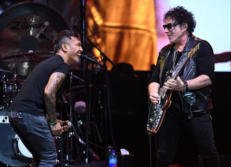 Singer Arnel Pineda (L) and  Neal Schon of Journey rock out a tune in Las Vegas. (Photo by Ethan Miller/Getty Images)